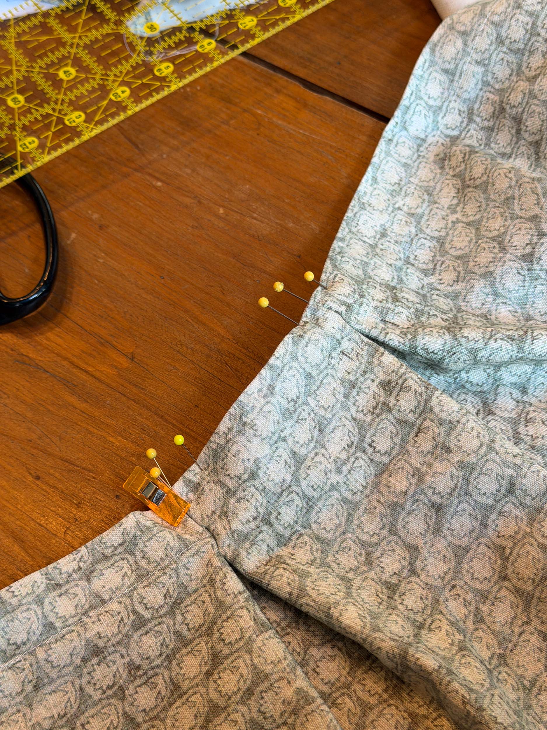 Several pleats being held in place with pins