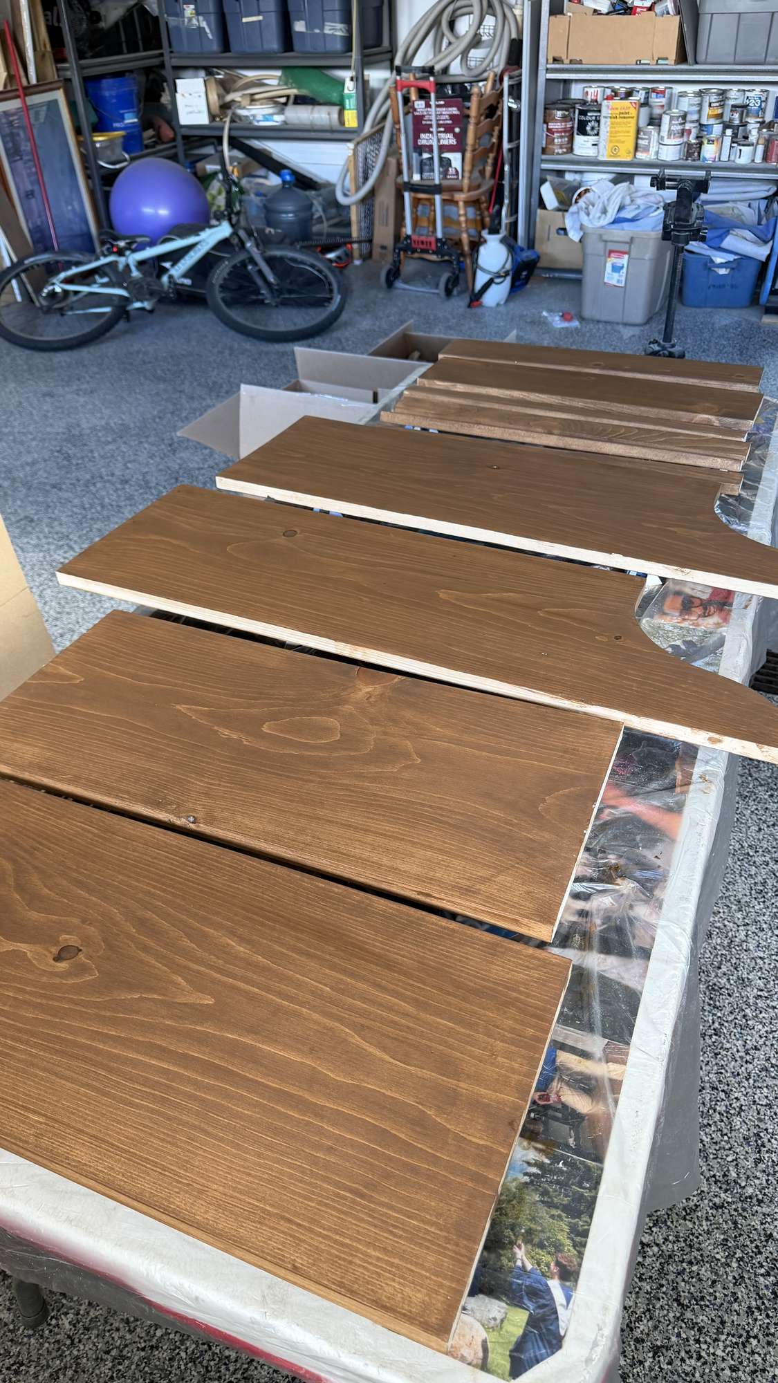 wood pieces for diy plate rack stained on a table