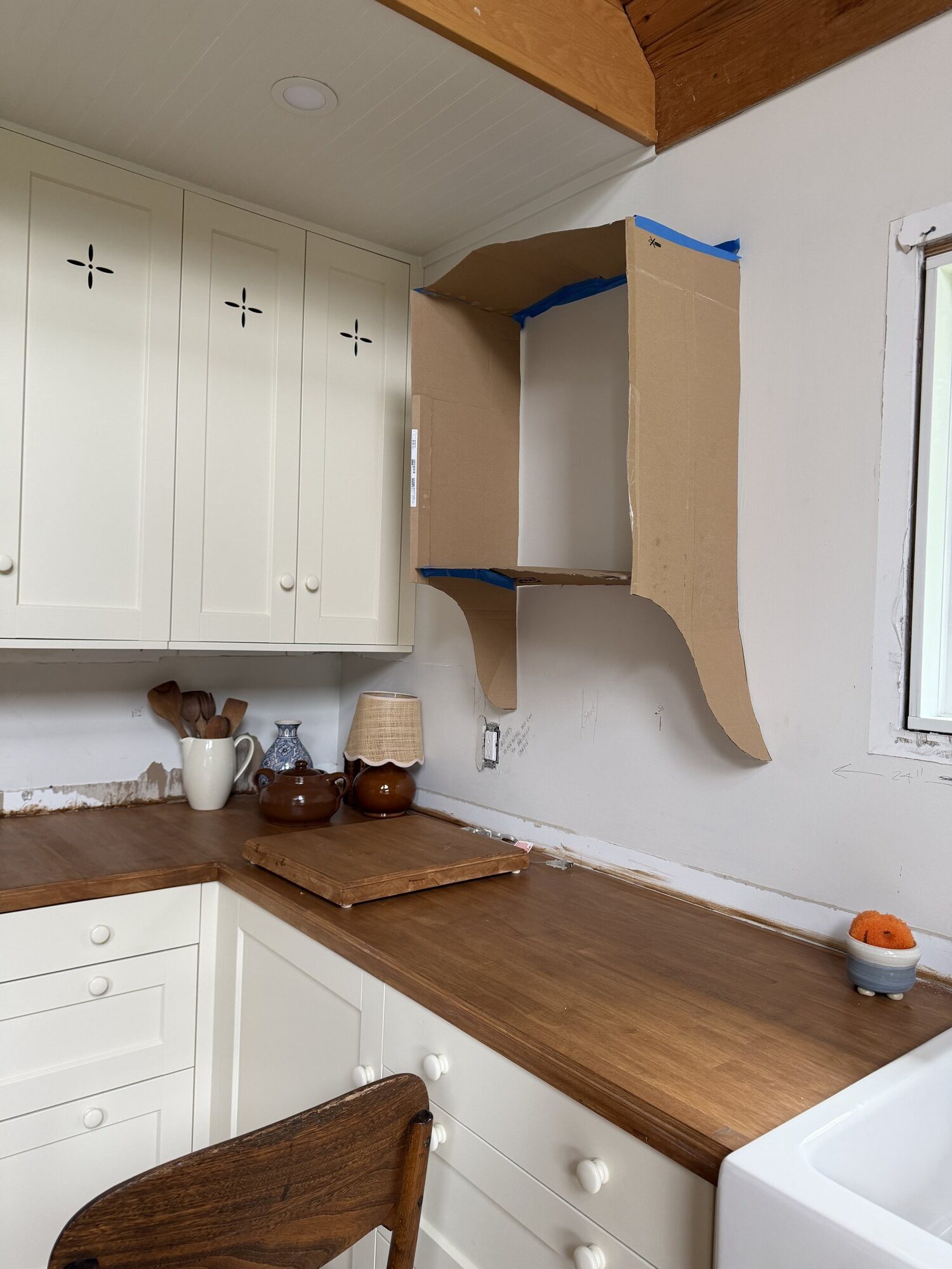 kitchen with cardboard box taped to the wall