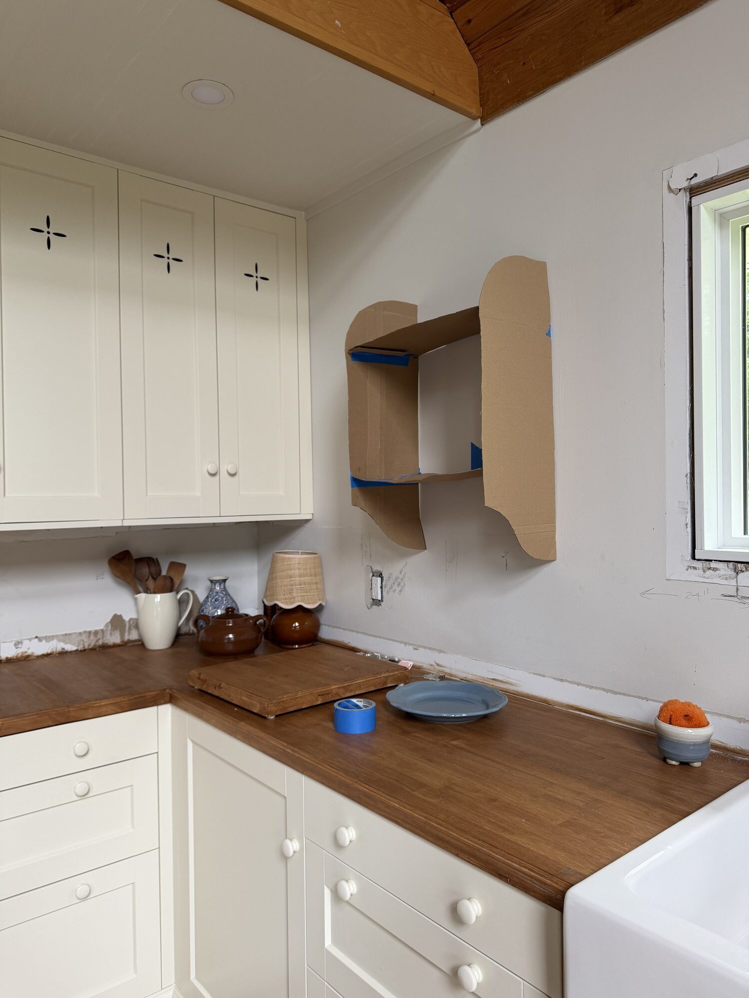 kitchen with cardboard box taped to the wall