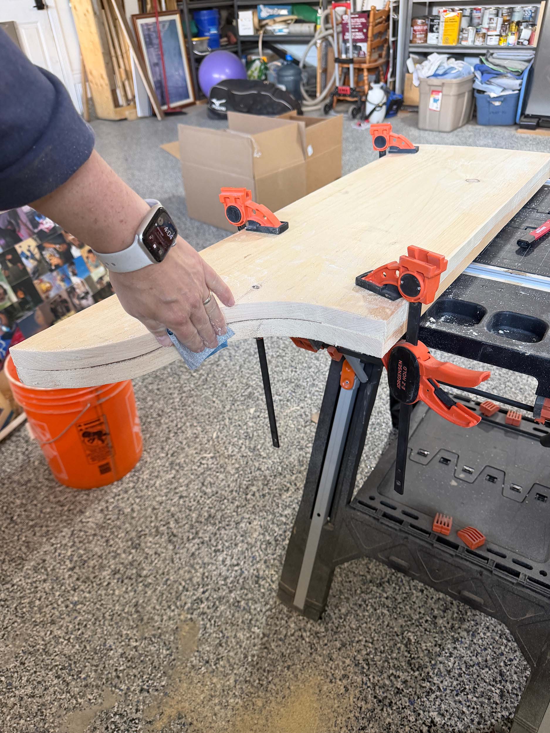 Two pieces of wood clamped together and being sanded at once