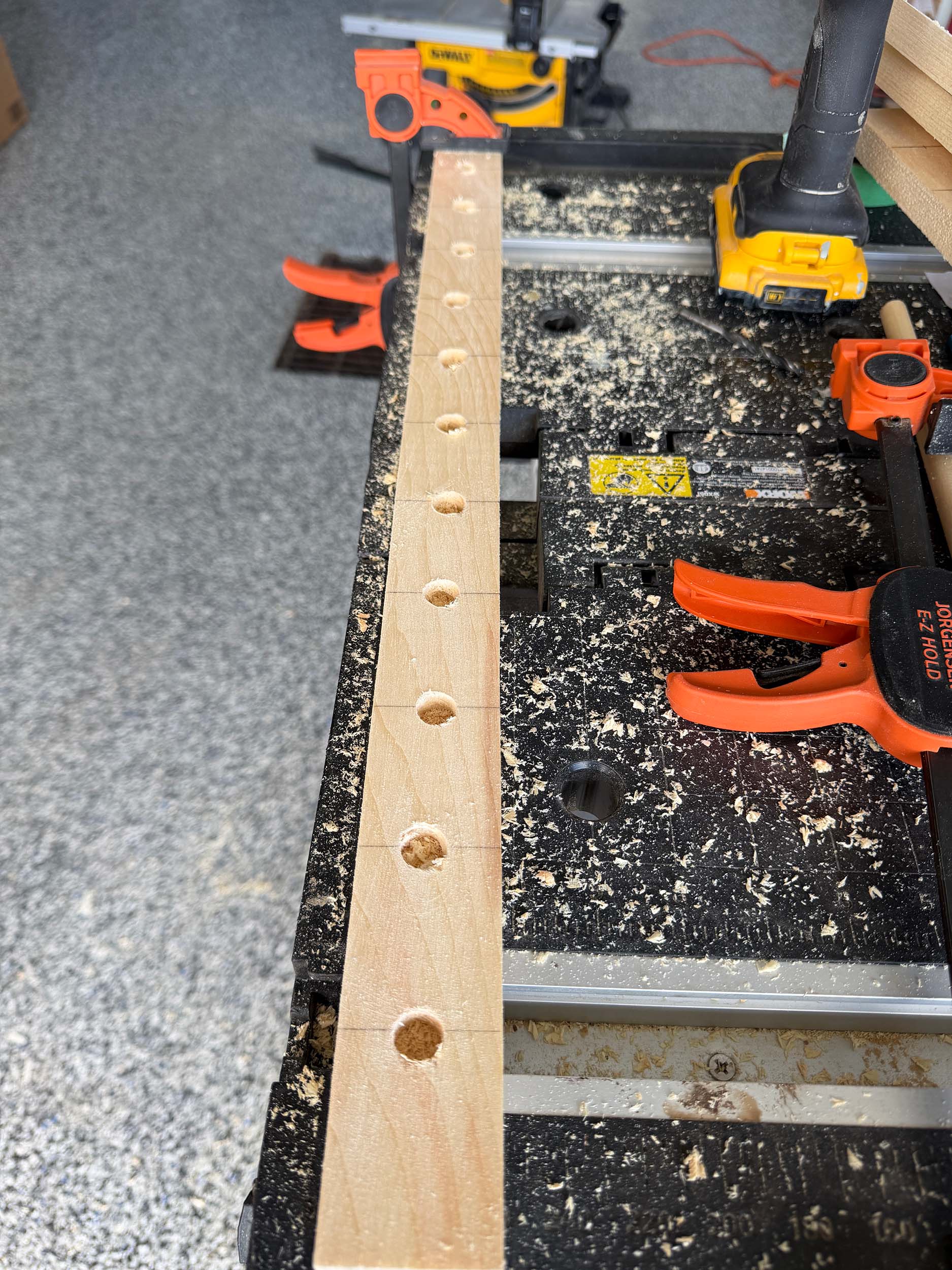 piece of wood with holes drilled every 2"