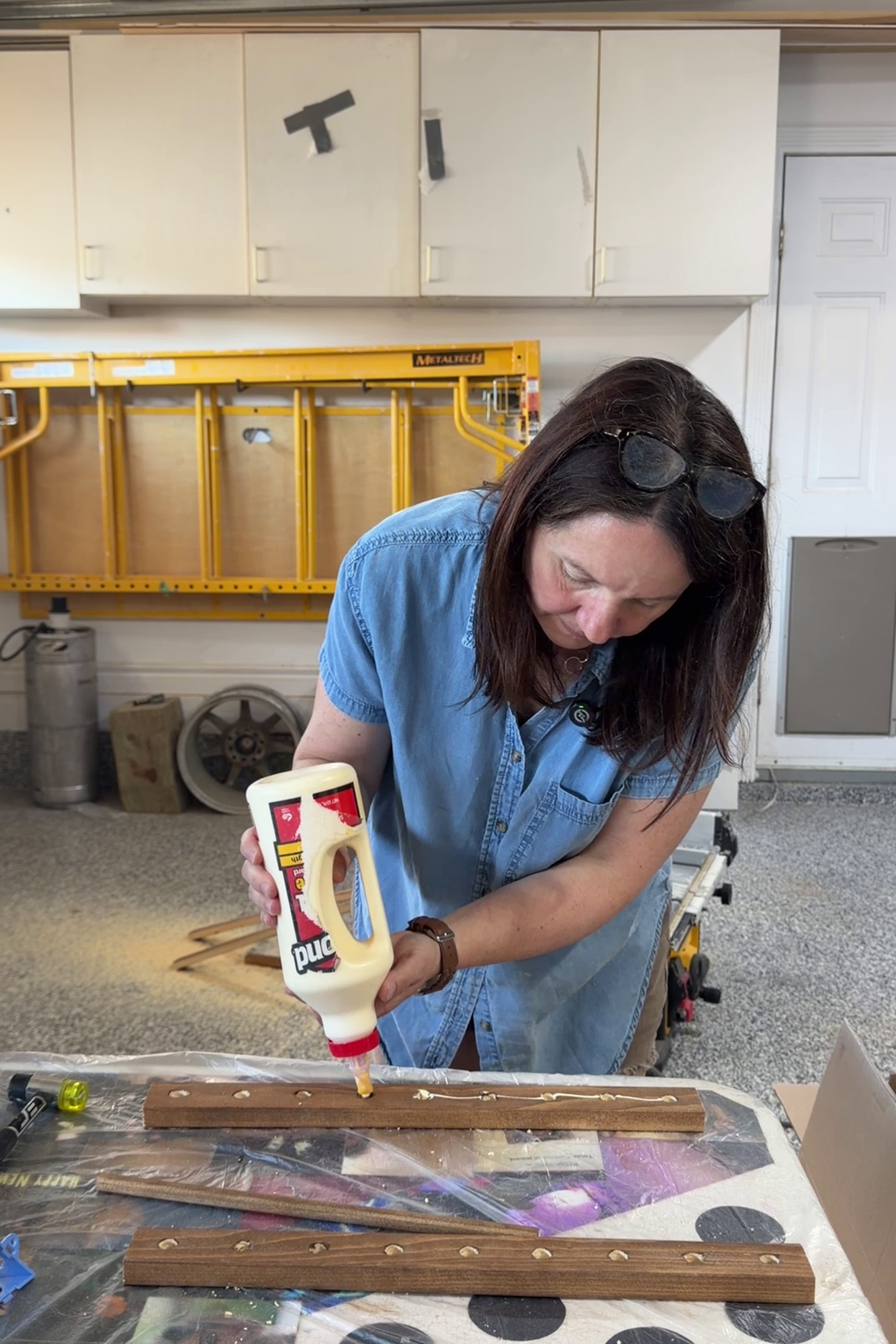 adding glue to dowel rail of diy plate rack