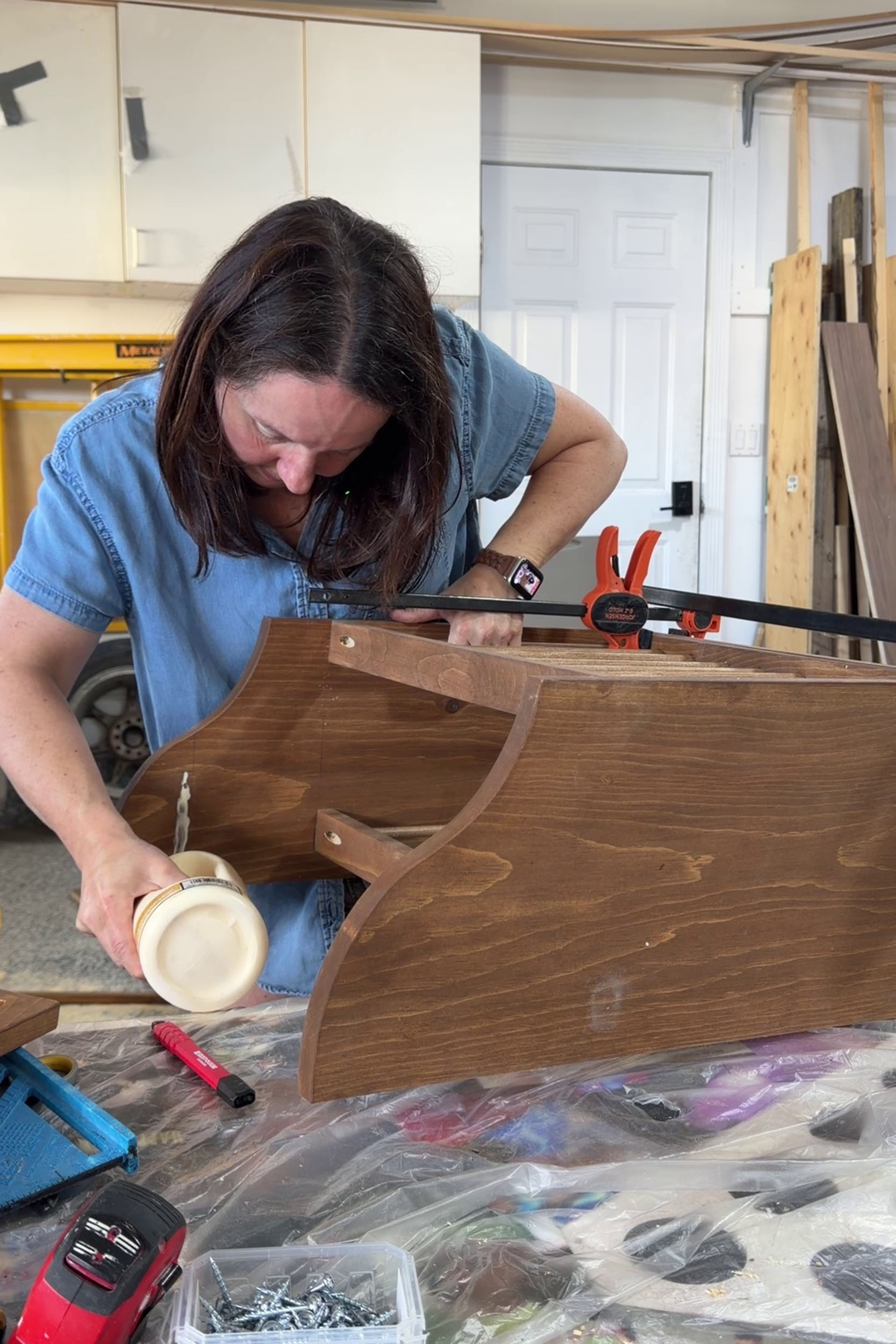 girl adding glue to plate rack